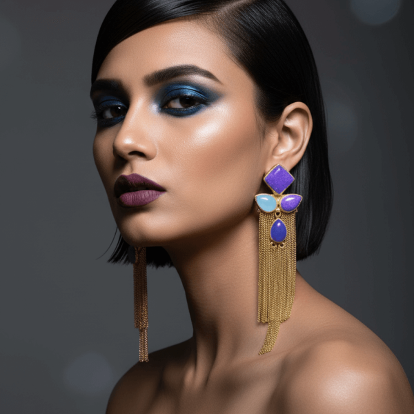 Belsi's Jewelry handcrafted gold tassel earrings with a cobalt blue square top, violet and sky blue teardrop stones, and a royal blue center on a white background.