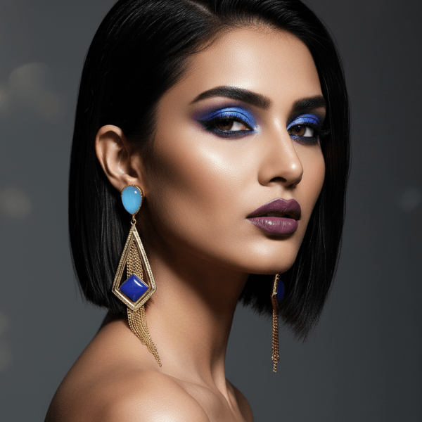 Belsi's Jewelry handcrafted gold geometric earrings with azure blue teardrop studs, cobalt square centers, and gold chain tassels on a white background.