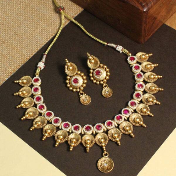 Polki-studded gold finish necklace set with traditional bridal design