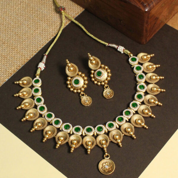 Polki-studded gold finish necklace set with traditional bridal design