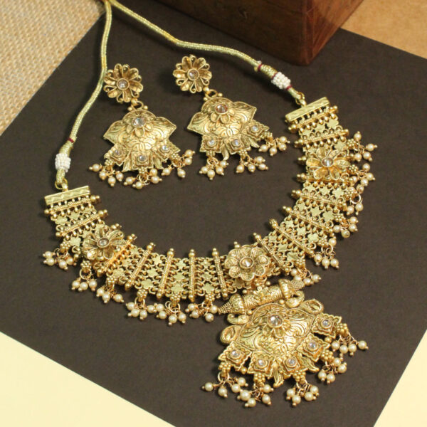 Polki-studded gold finish necklace set with traditional bridal design