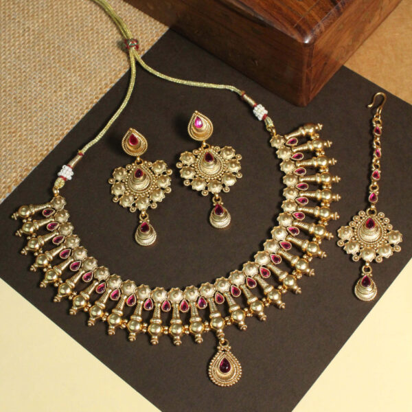 Polki-studded gold finish necklace set with traditional bridal design