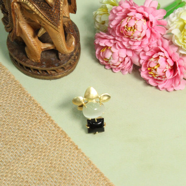 A handcrafted natural stone ring with a gemstone set in a minimalist band