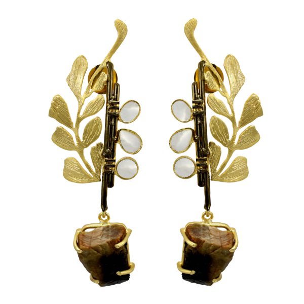 “Woman wearing gold unique metal statement earrings featuring leaf motifs, polki accents, and stone drops elegant handcrafted jewelry by Belsis.”
