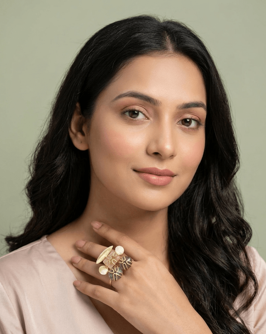 Labradorite and Peach Moonstone Statement Ring – Handcrafted Gold Wire-Wrapped Cocktail Ring 1 lifestyle shot of a woman wearing an intricate gold ring with iridescent labradorite and peach caged gemstones on her hand.