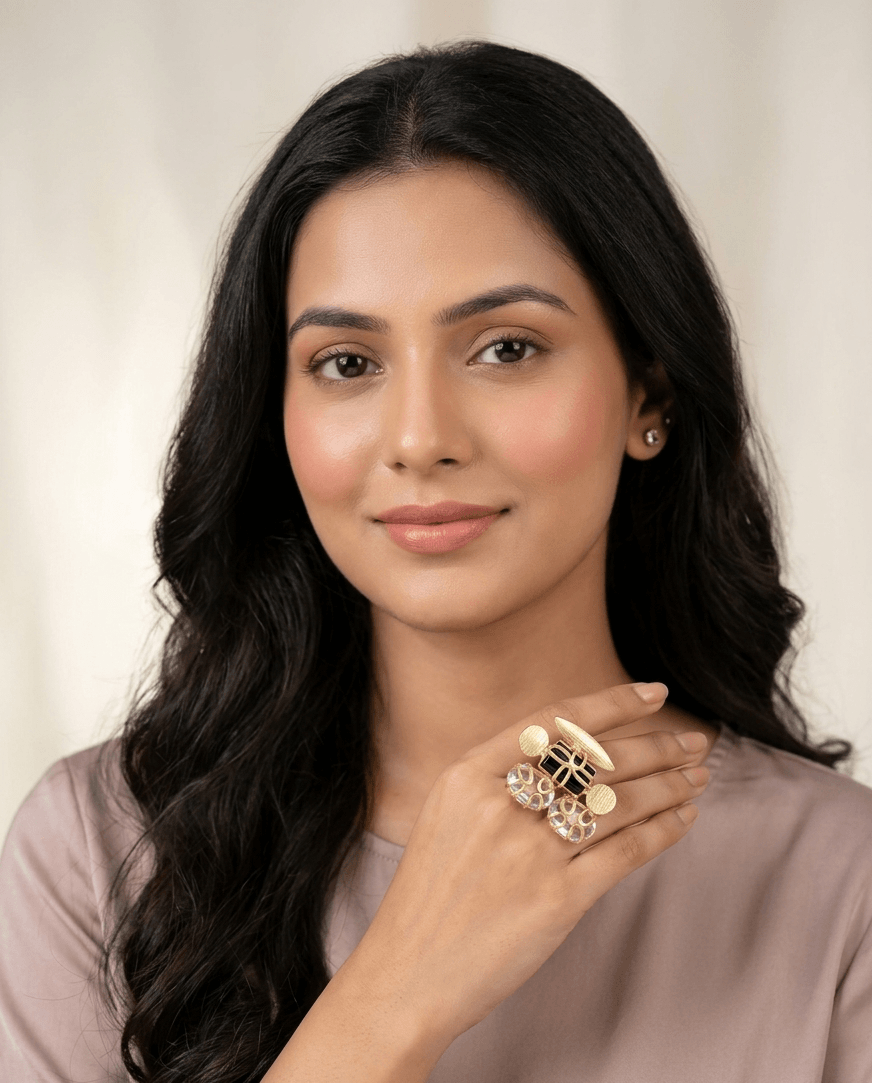 Black Onyx and Moonstone Statement Ring – Handcrafted Gold Wire-Wrapped Cocktail Ring 1 A lifestyle shot of a woman wearing an intricate gold ring with black onyx and white caged moonstones on her hand.