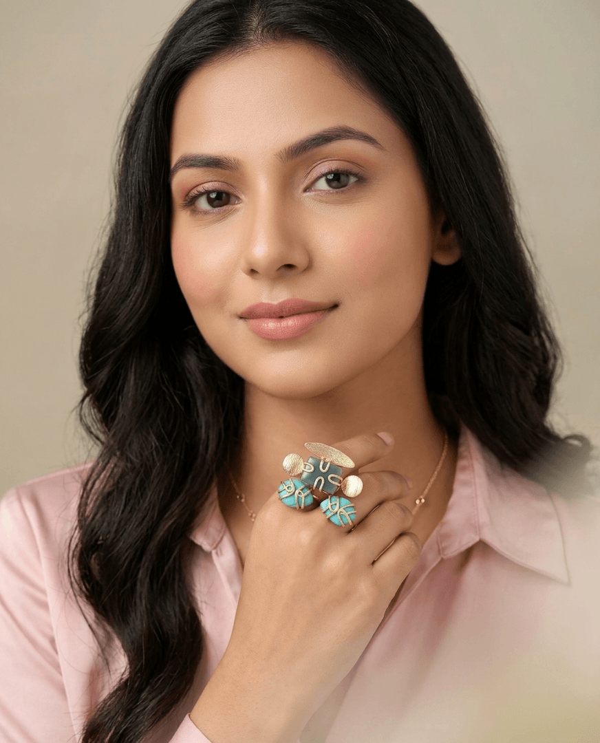 Amazonite and Turquoise Statement Ring – Handcrafted Gold Wire-Wrapped Cocktail Ring 1 A lifestyle shot of a woman wearing an intricate gold ring with teal amazonite and bright blue caged turquoise gemstones on her hand.
