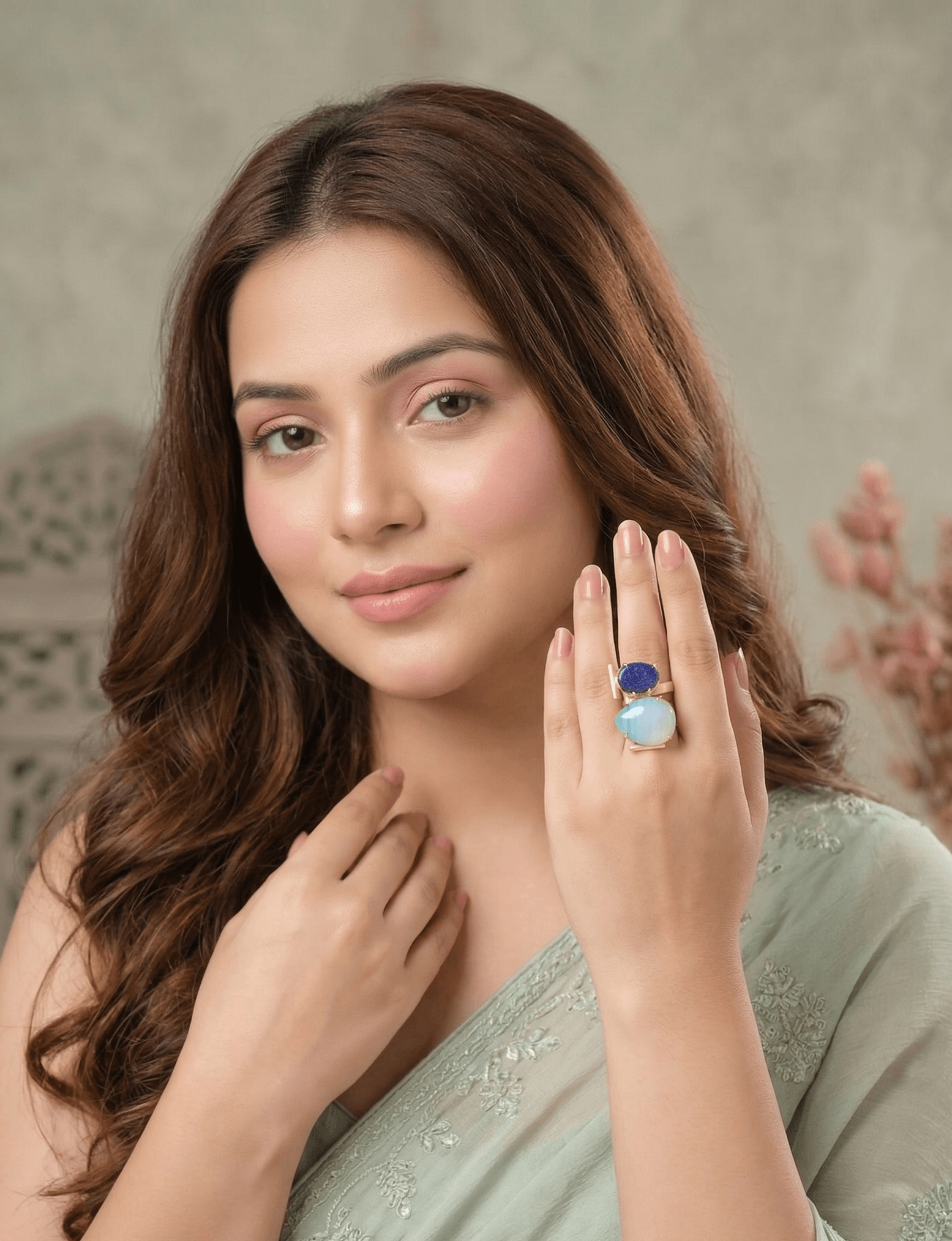 Lapis Lazuli and Moonstone Architectural Statement Ring – Handcrafted Gold Geometric Dual-Stone Ring 1 A lifestyle close-up of a woman in a green saree wearing an intricate gold geometric ring featuring a blue lapis lazuli and a large white moonstone.