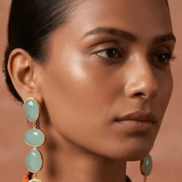 Belsi's Jewelry multi-tier statement drop earrings featuring four graduated, faceted seafoam mint green quartz stones encased in handcrafted gold-plated frames.