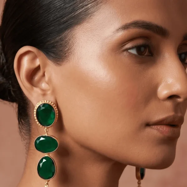 Belsi's Jewelry multi-tier statement drop earrings featuring emerald green faceted quartz stones paired with a vibrant turquoise blue drop element in a handcrafted gold-plated frame.