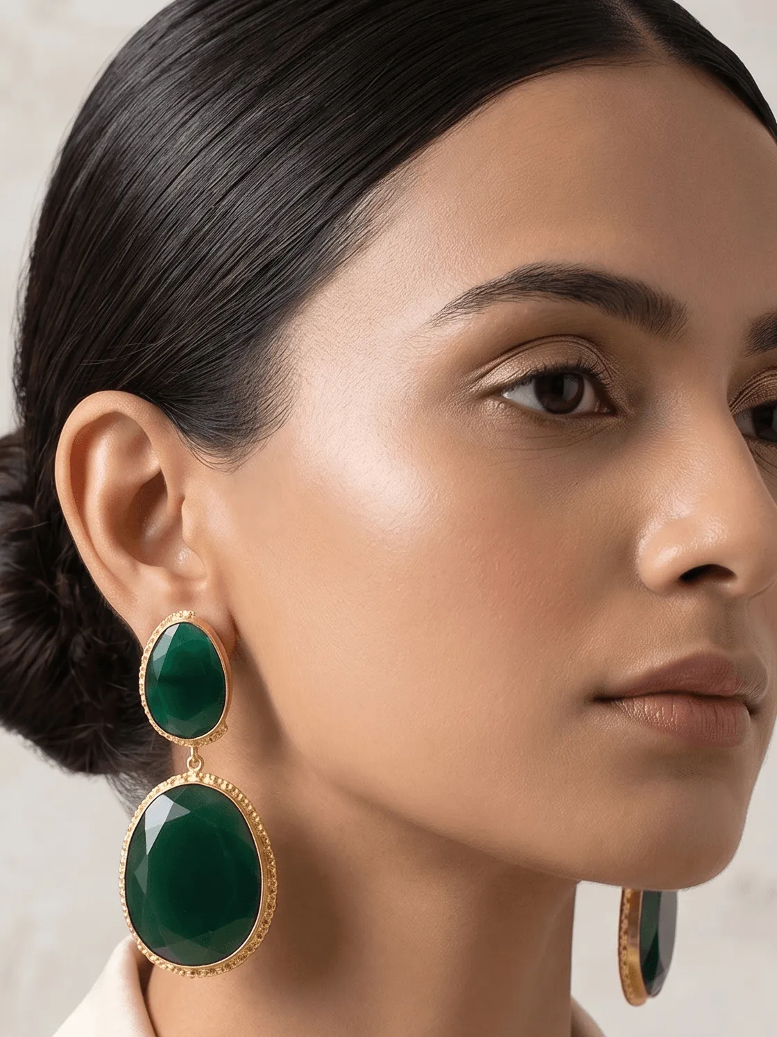 Emerald Green Quartz Two-Tier Drop Earrings 1 Belsi's Jewelry two-tier statement drop earrings featuring an oval emerald green quartz top stone and a large, faceted deep green teardrop crystal encased in handcrafted gold-plated borders.