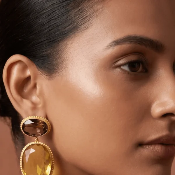 Belsi's Jewelry two-tier statement drop earrings featuring an oval smoky brown quartz top stone and a large, faceted citrine yellow teardrop crystal encased in handcrafted gold-plated borders.