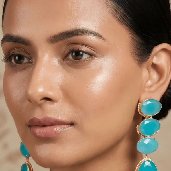 Belsi's Jewelry multi-tier linear statement drop earrings featuring four graduated, faceted aqua blue quartz stones encased in handcrafted gold-plated frames.