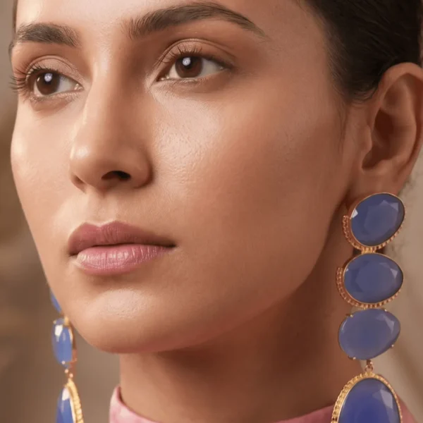 Belsi's Jewelry multi-tier statement drop earrings featuring four graduated, faceted periwinkle lavender blue quartz stones encased in handcrafted gold-plated frames.